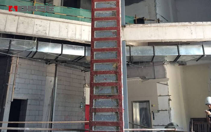 Reinforced concrete columns are wrapped with steel